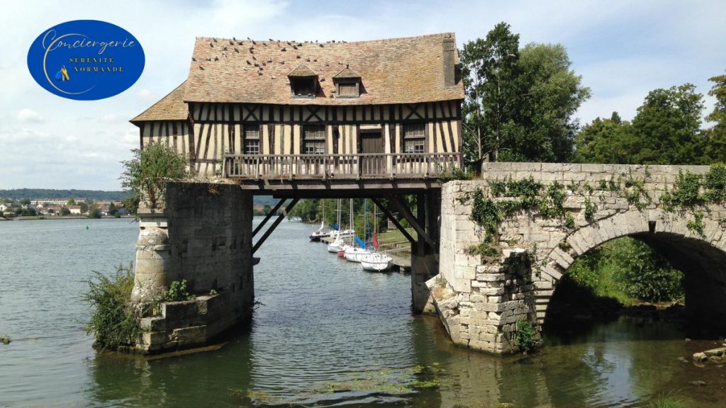 7 façons puissantes dont la conciergerie dynamise l'économie locale 1 Ancien moulin de Vernon sur la Seine, illustrant le rôle de la conciergerie dans la mise en valeur du patrimoine local